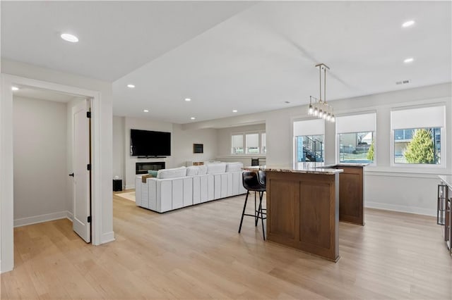 kitchen featuring light wood-style flooring, a wealth of natural light, and a center island