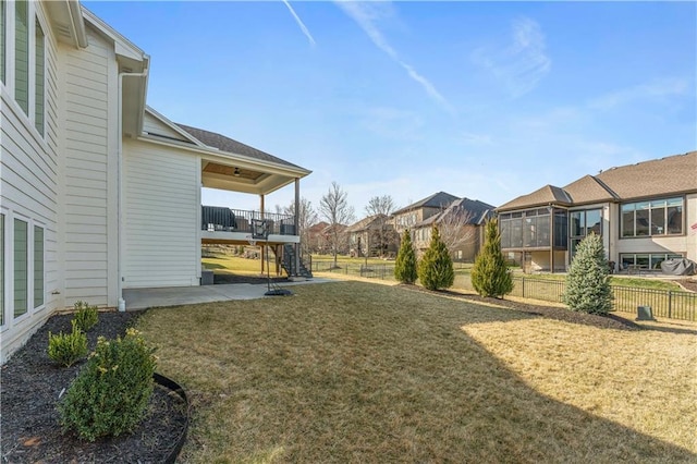 view of yard with a patio area, fence, and a residential view