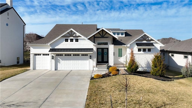 view of front facade featuring driveway, a front yard, a standing seam roof, and metal roof