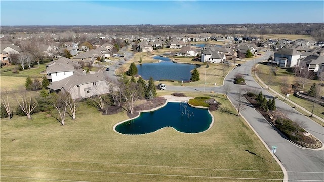 birds eye view of property with a residential view and a water view