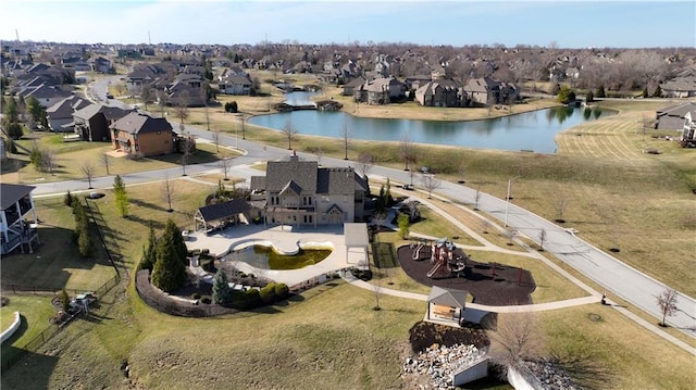 drone / aerial view with a residential view and a water view