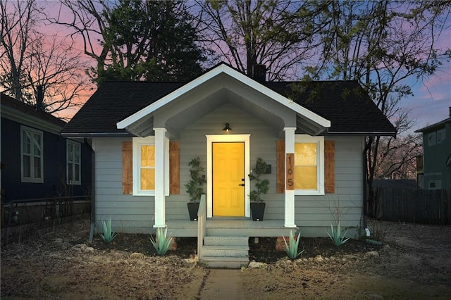 bungalow-style house featuring fence