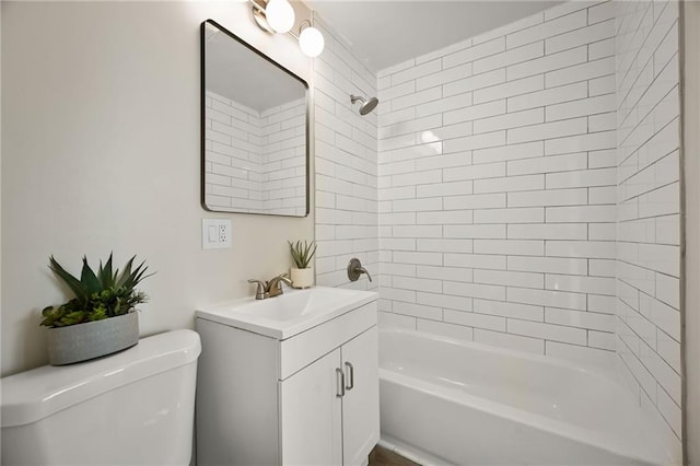 bathroom featuring tub / shower combination, toilet, and vanity