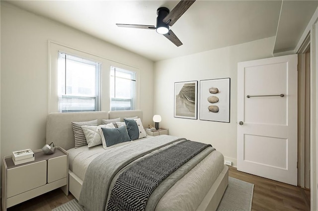 bedroom featuring dark wood-style floors and ceiling fan