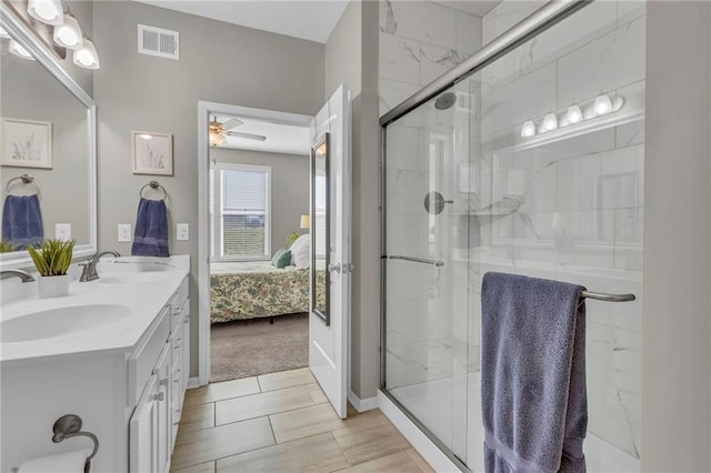 full bathroom featuring visible vents, connected bathroom, a stall shower, and a sink