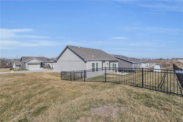 view of side of property with a yard, a residential view, and fence