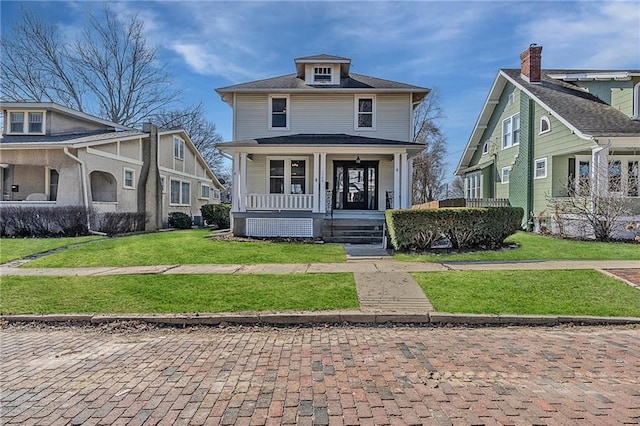 traditional style home featuring a porch and a front lawn