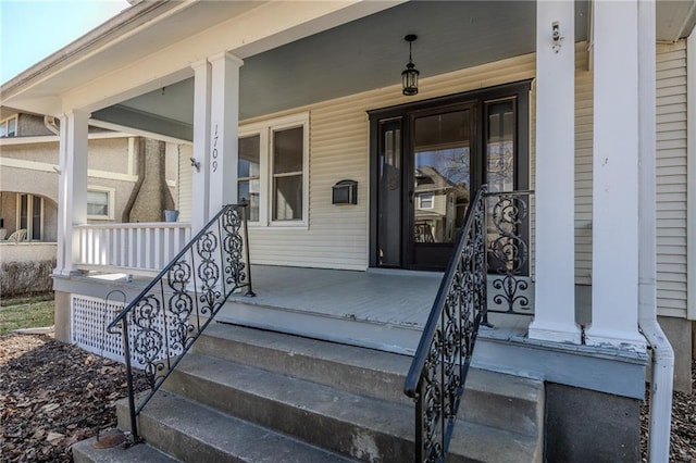 view of exterior entry featuring a porch