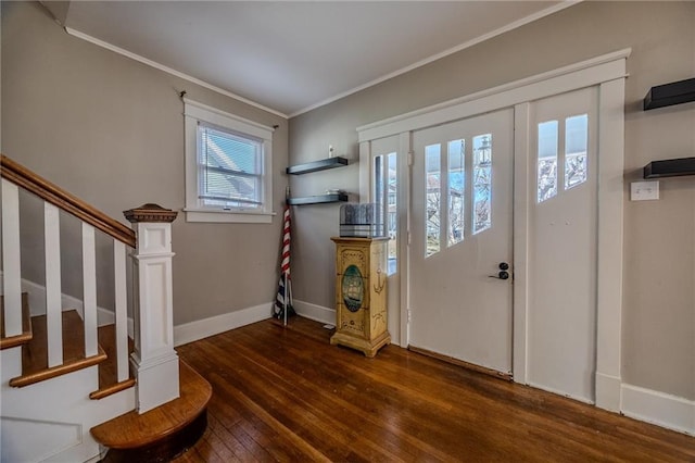 foyer with stairs, crown molding, baseboards, and hardwood / wood-style floors