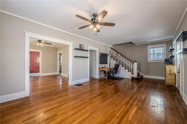 unfurnished living room with baseboards, stairway, ornamental molding, hardwood / wood-style flooring, and a ceiling fan