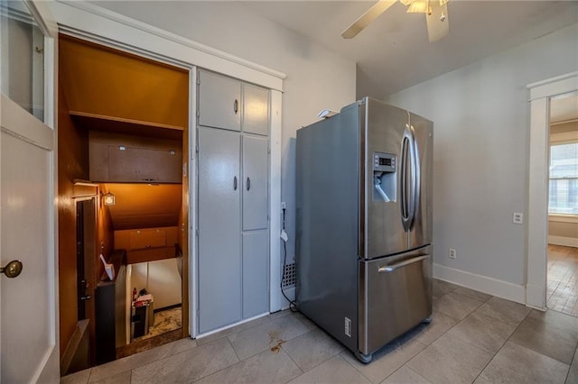 kitchen with light tile patterned flooring, stainless steel fridge, baseboards, and ceiling fan