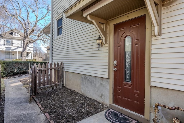 view of exterior entry featuring fence