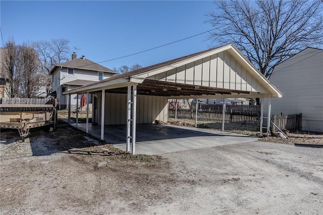 exterior space with a carport, driveway, and fence