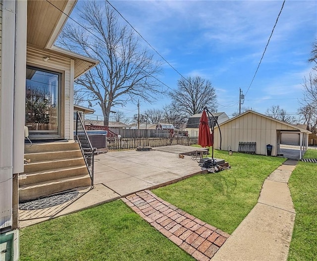 view of yard with a patio area, an outbuilding, and fence