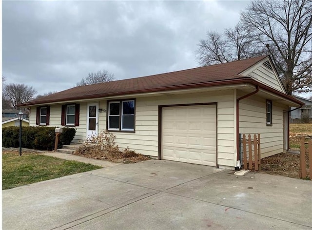 ranch-style home with an attached garage and driveway