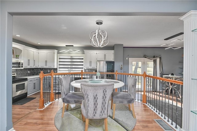 11705 E 86th Ter, Raytown, MO 64138 - dining space with a chandelier, light wood-style floors, and recessed lighting