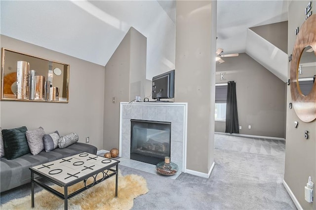 11705 E 86th Ter, Raytown, MO 64138 - carpeted living room featuring lofted ceiling, a ceiling fan, a tile fireplace, and baseboards