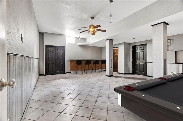 11705 E 86th Ter, Raytown, MO 64138 - recreation room with a textured wall, ceiling fan, tile patterned flooring, billiards table, and a textured ceiling