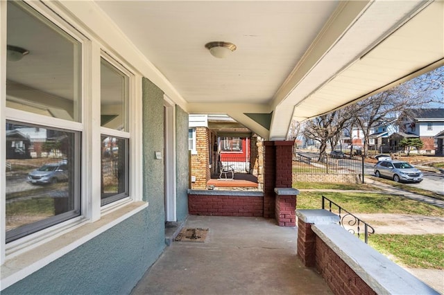 view of patio featuring covered porch and a residential view