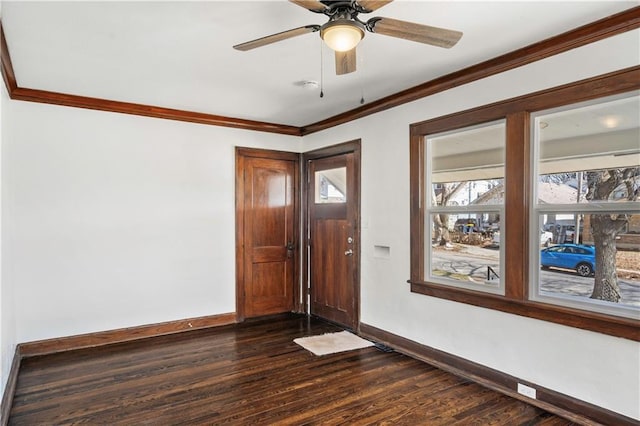 foyer entrance featuring dark wood-style floors, ceiling fan, baseboards, and ornamental molding