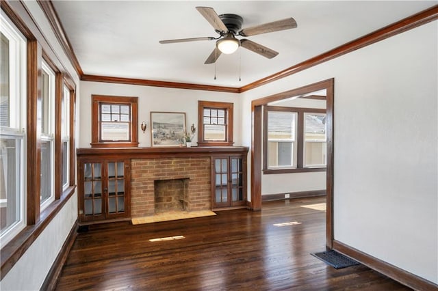 unfurnished living room featuring visible vents, baseboards, ornamental molding, wood finished floors, and a ceiling fan