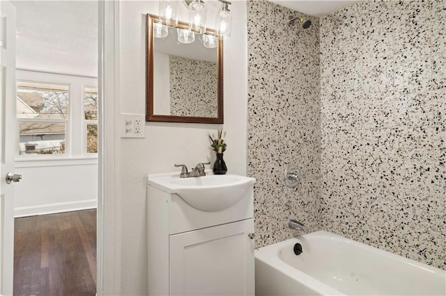 full bath with tub / shower combination, vanity, and wood finished floors