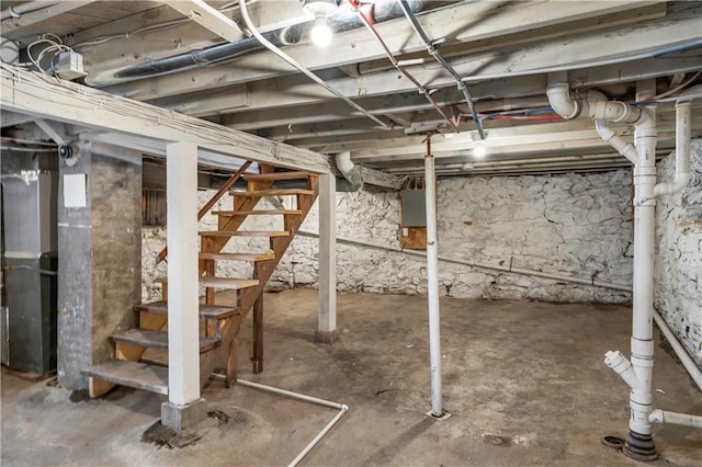 unfinished basement featuring stairway