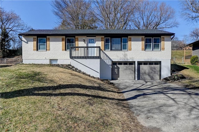 view of front facade featuring brick siding, a front lawn, stairs, a garage, and driveway