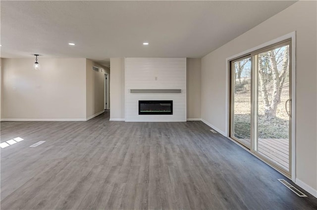 unfurnished living room featuring visible vents, recessed lighting, baseboards, and wood finished floors