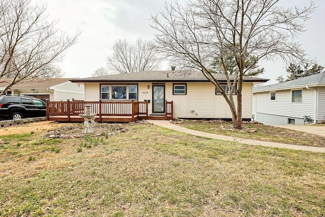 ranch-style home featuring a deck and a front lawn