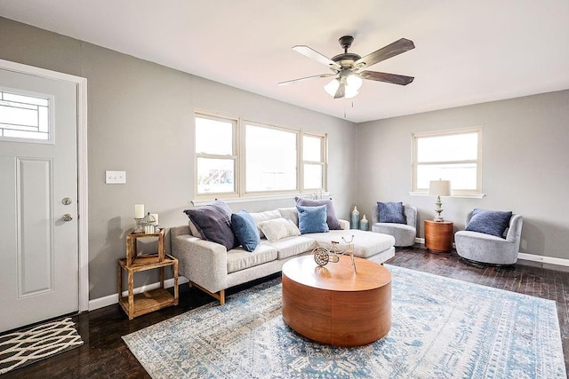 living room featuring baseboards, dark wood-type flooring, and a ceiling fan