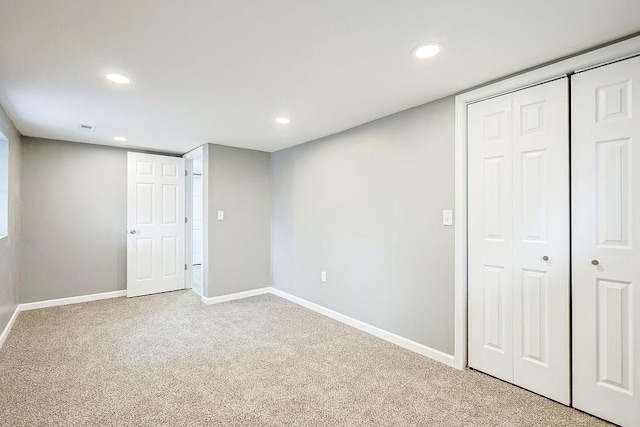 unfurnished bedroom featuring recessed lighting, light colored carpet, and baseboards