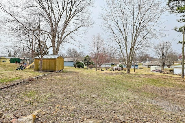 view of yard featuring an outbuilding and a storage unit