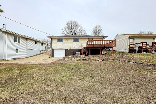 back of house with a garage, a wooden deck, driveway, and stairway