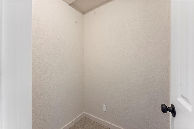 spare room with baseboards and a textured wall