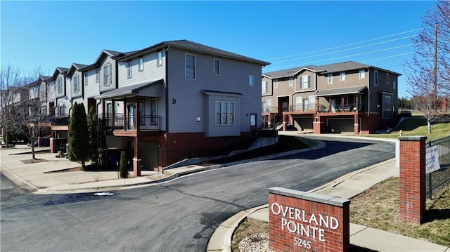 view of road featuring curbs, a residential view, and sidewalks