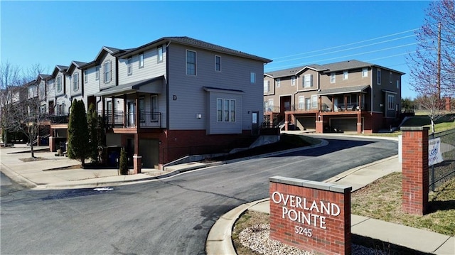 view of road featuring curbs, a residential view, and sidewalks