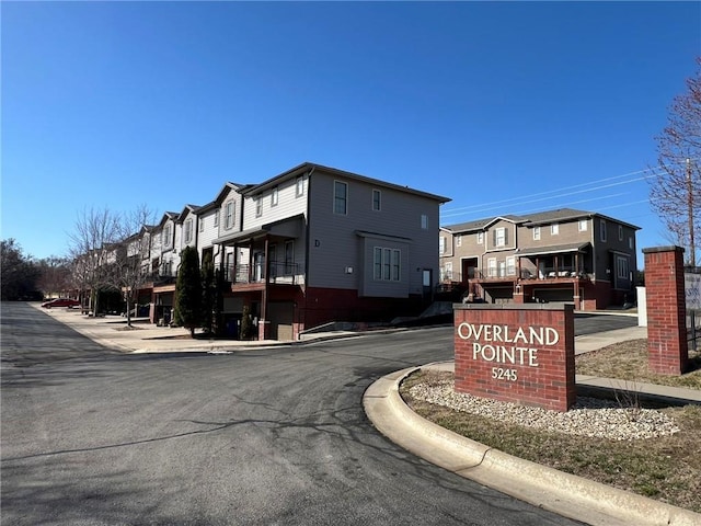 view of road with curbs and a residential view