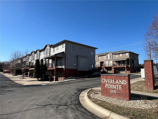 view of road with sidewalks, curbs, and a residential view