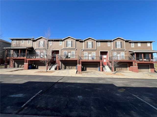 townhome / multi-family property with stairway and driveway