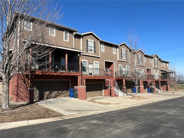 view of front of property with brick siding, driveway, and an attached garage