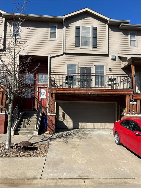 view of property featuring a garage and driveway