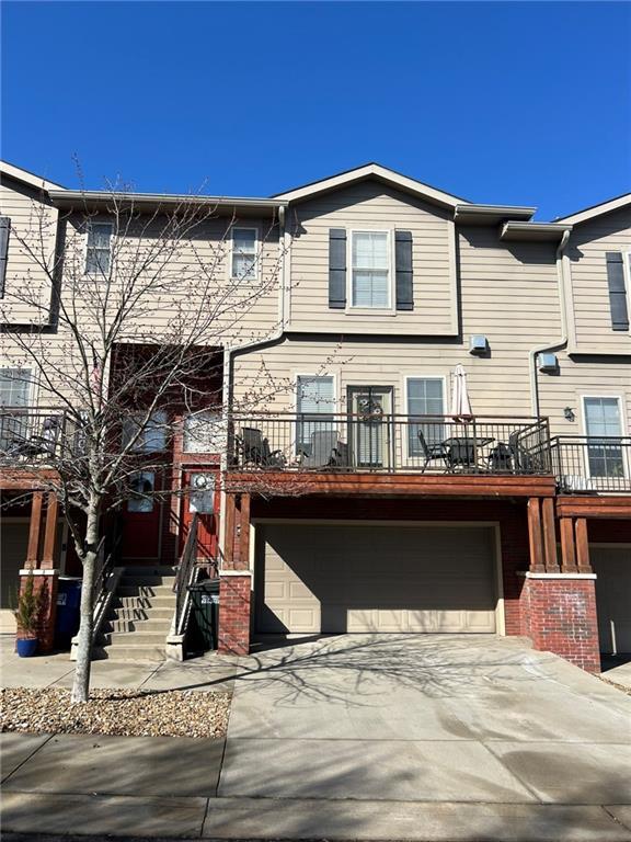 townhome / multi-family property with concrete driveway and an attached garage