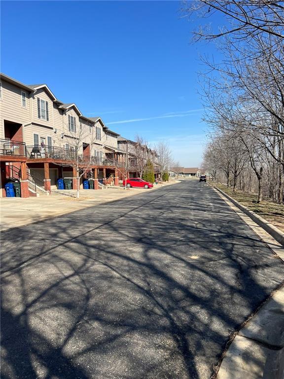 view of street with curbs and a residential view