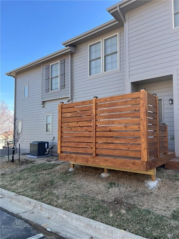 view of home's exterior with central AC and a wooden deck