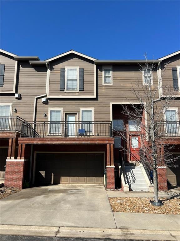 townhome / multi-family property with a garage and driveway