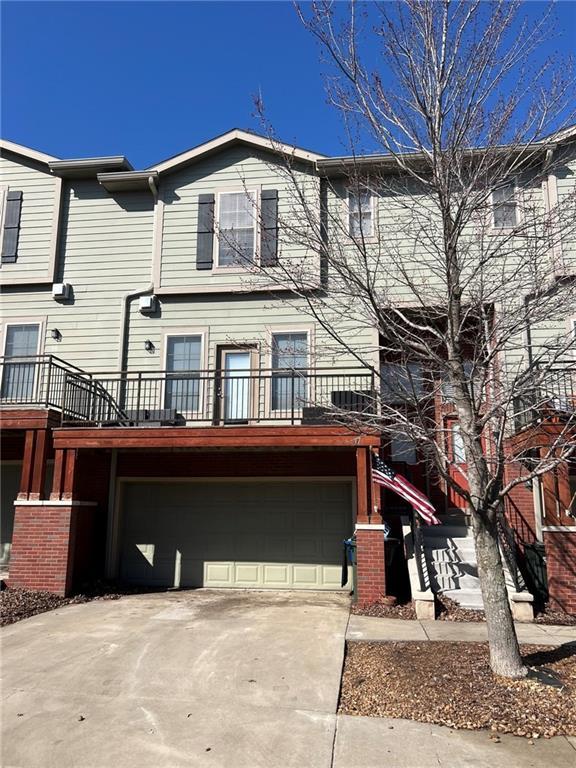 townhome / multi-family property featuring concrete driveway and a garage