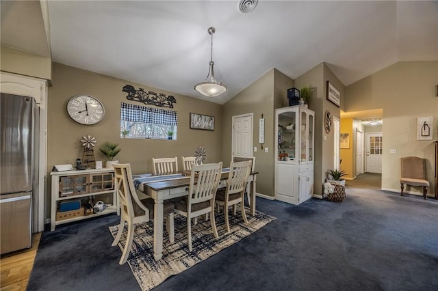 dining area with baseboards, carpet flooring, and vaulted ceiling