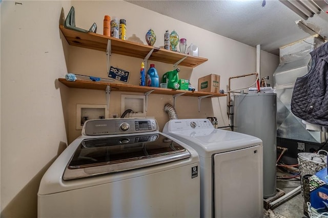 washroom with washer and dryer, laundry area, and water heater