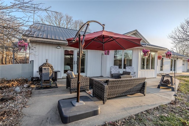 back of house with an outdoor living space, fence, french doors, metal roof, and a patio